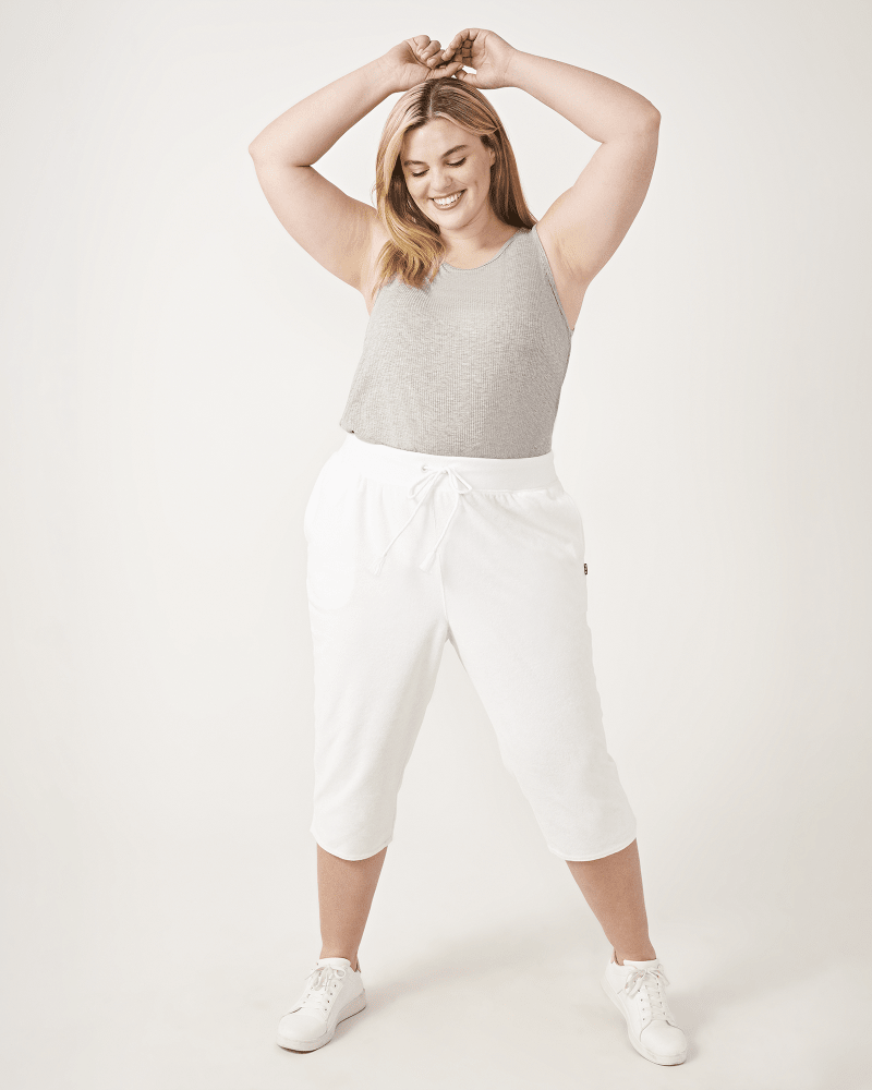 Plus size model with hourglass body shape wearing Sydney Cropped Joggers by FILA | Dia&Co | dia_product_style_image_id:161017